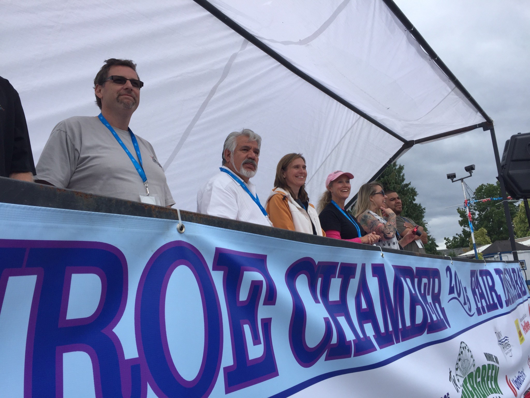 Community leaders gathered on a chamber parade reviewing stand